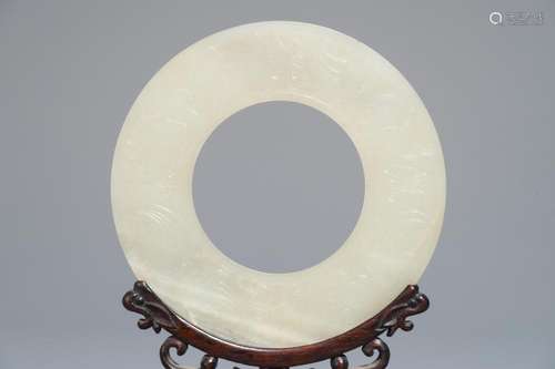 A Chinese pale celadon jade bi disc, Ming or earlier