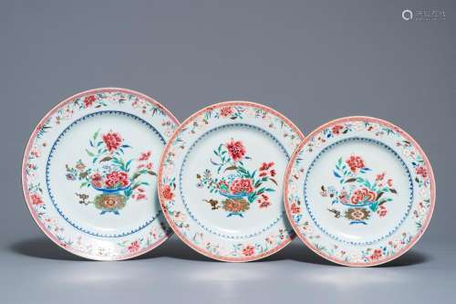 Three Chinese famille rose chargers with flower vases, Qianlong