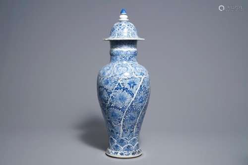 A Chinese blue and white moulded vase and cover with floral design, Kangxi
