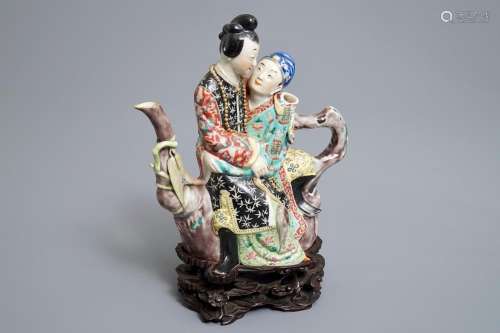 A Chinese famille rose semi-erotic teapot on wooden stand, Republic, 20th C.