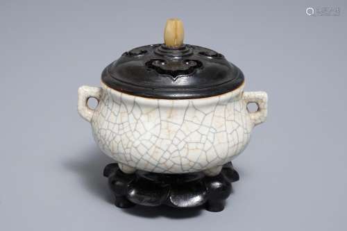 A Chinese ge-type crackle glazed tripod censer and cover on stand, 19/20th