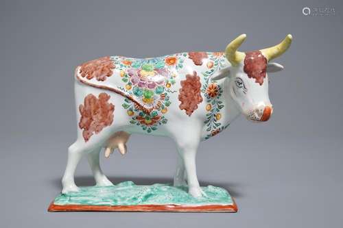 A polychrome Dutch Delft petit feu cow on base, 18th C.