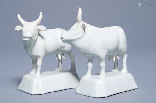 A pair of white Dutch Delft models of cows on bases, 18th C.