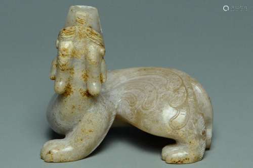 A HAN DYNASTY CARVED JADE FIGURE OF A BIXIE