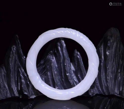 A HETIAN JADE CARVED BANGLE