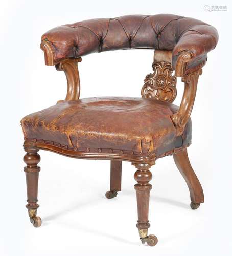 A Victorian mahogany desk chair, button upholstered with maroon leather, the splat carved with