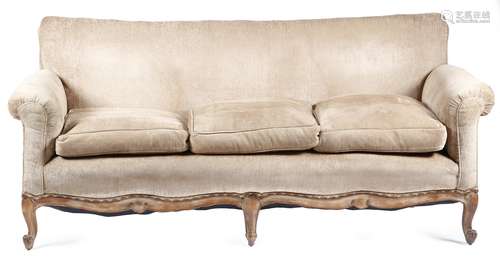 A French beechwood three seater sofa in Louis XV style, with scroll arms, above a moulded frame,