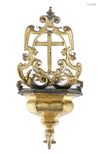 A mid-18th century continental gilt bronze holy water stoup, the pierced back centred with a