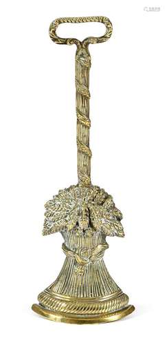 A 19th century brass wheatsheaf doorstop, with an open handle, on a reeded leaf decorated stem and a