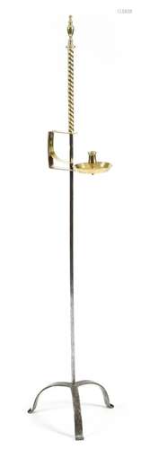 A brass and wrought iron adjustable candlestand, with an urn finial above an adjustable sconce, with