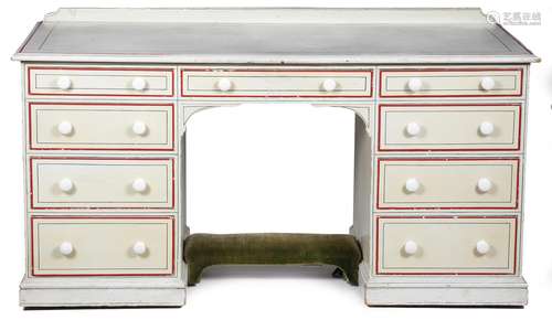 A late Victorian painted pine twin pedestal desk, with a raised back, above an arrangement of nine