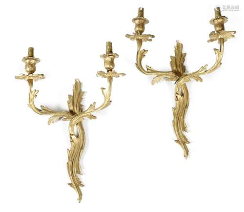 A set of four ormolu twin-light wall appliques in Louis XV style, 43.3cm high, 31.7cm wide. (4)