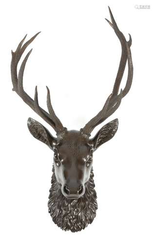 A late 19th century Black Forest carved and painted wood royal stag head mount, applied with a set