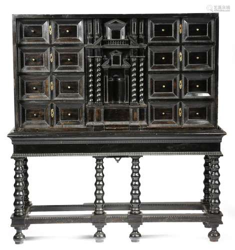 A late 17th century Flemish ebony and ebonised cabinet, of architectural form, with two banks of