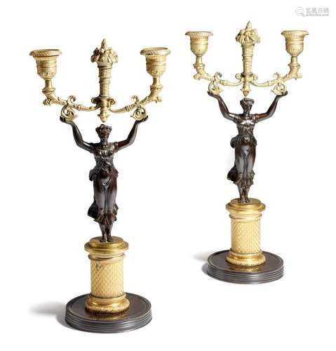 A pair early 19th century French gilt and patinated bronze figural twin-light candlesticks, each