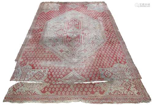 A large Turkish Ushak 'Waterloo' carpet, with a central diamond medallion, West Anatolia, cuts and