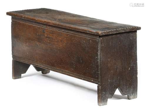 A small early 17th century six plank coffer, the hinged top with a moulded front edge and grooved