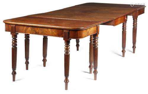 A Regency mahogany dining table, with a plain frieze and reeded tablet headed turned and tapering