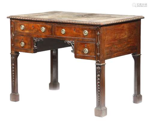 A mahogany kneehole desk in 18th century style, the panelled top inset with tooled leather, with a