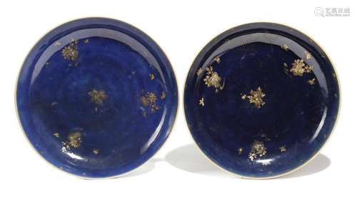 A pair of Chinese Imari saucer dishes, the interiors with a blue glaze and decorated in gilt with