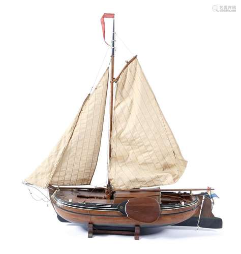 A 20th century model of a Dutch barge, with fittings, masts and sails, on a cradle stand, 16.5cm