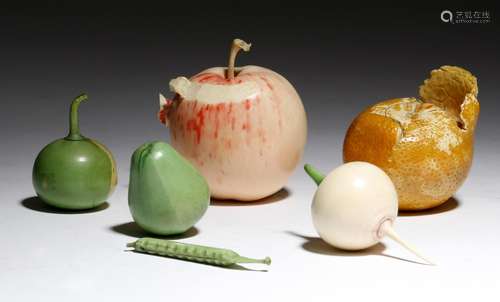 λ Two Japanese carved and painted ivory okimono of fruit, one of an apple, the skin partially peeled