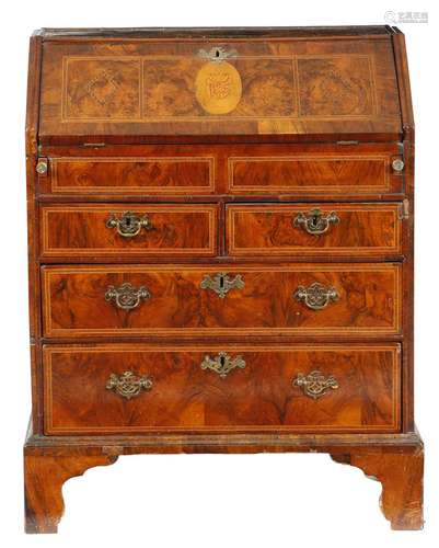 An early 18th century walnut bureau, inlaid with later banding and marquetry, the interior with an