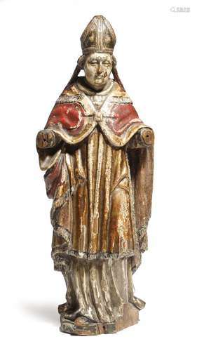 A continental carved wood and polychrome decorated figure of a bishop, with parcel gilt