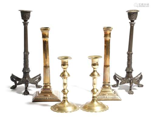 A pair of late 19th century French bronze candlesticks, the nozzles decorated with a warrior on