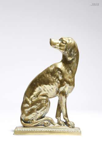 A Victorian brass doorstop, in the form of a seated dog, with a registration lozenge and numbered '