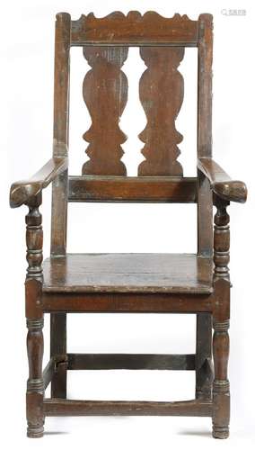 A planewood and fruitwood armchair, with a serpentine crest above a twin splat back, with