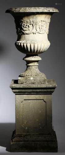 A garden urn on plinth, probably Haddonstone, with an egg and dart everted rim above a band of