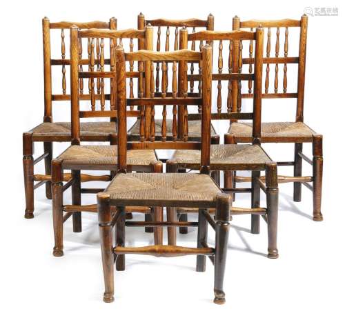 A set of six Lancashire ash dining chairs, each with a spindle back, above a rush seat, on turned