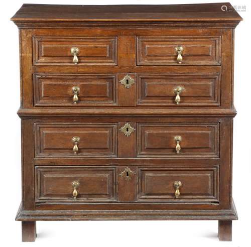A late 17th century oak chest, in two halves, with two short and three long panelled drawers, with