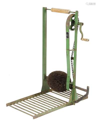 A cast iron country house boot cleaner, painted green, with a rotary mechanism and a hedgehog brush,