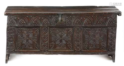 A 17th century elm six plank coffer, the hinged lid with a moulded front and grooved sides,