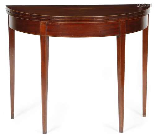 A George III mahogany demi-lune card table, inlaid with boxwood stringing, the fold-over top on twin