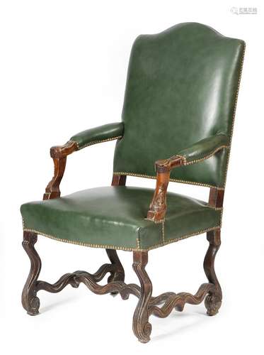 An 18th century French os de mouton armchair, the padded back seat and armrest upholstered with