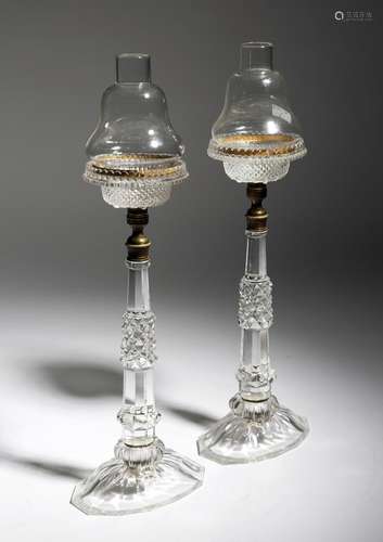 A pair of late Victorian cut-glass cricklite candle lamps, each with a detachable shade, with an