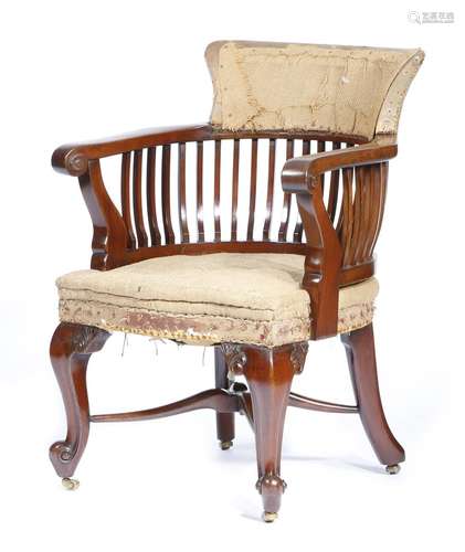 A mahogany desk chair in George III style, with scroll arms, on leaf carved cabriole legs and