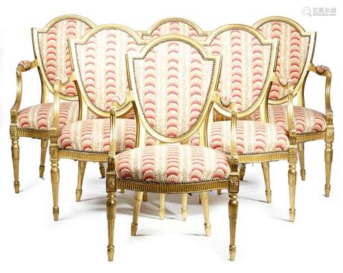 A set of six giltwood open armchairs in George III style, each with a shield back, the moulded