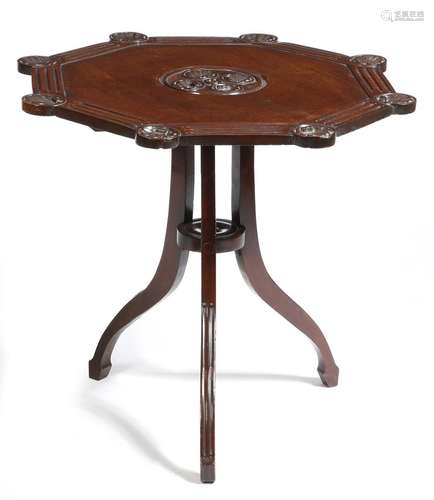 A mahogany tripod table, the octagonal tilt-top carved with shell rondels, on fluted splay legs,