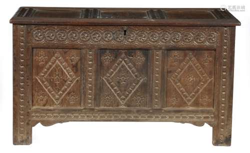 A 17th century triple panelled oak coffer, the interior with a lidded till, the guilloche frieze