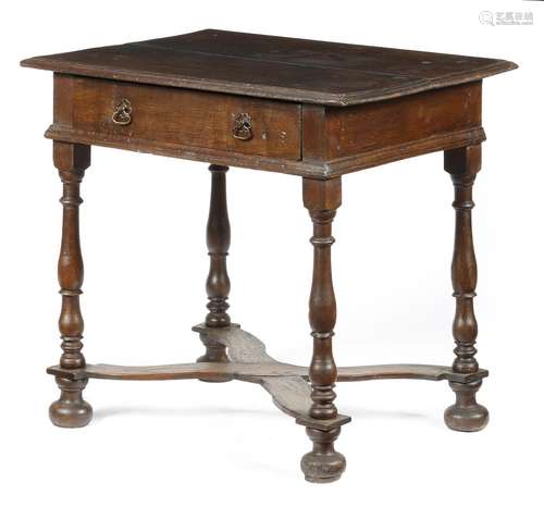 A Queen Anne oak side table, the boarded top with a moulded edge, above a frieze drawer, on baluster