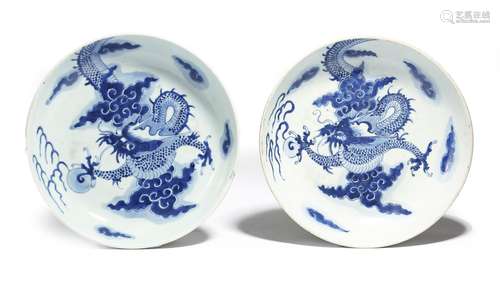 A matched pair of Chinese porcelain blue and white saucer dishes, each decorated with scaly