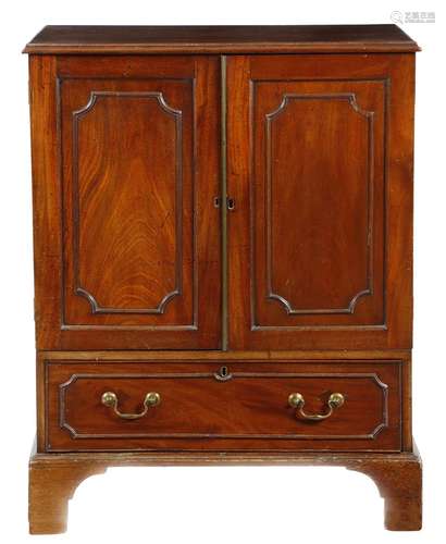 A small mahogany linen press in George III style, with a pair of cupboard doors with outline