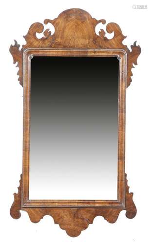 A George II walnut fret-frame wall mirror, the later arched plate within a moulded frame and