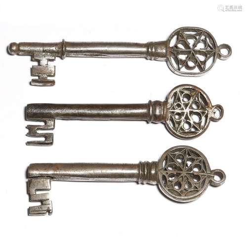 Three 16th century Italian Venetian iron keys, each with a pierced Gothic bow and with a ring for