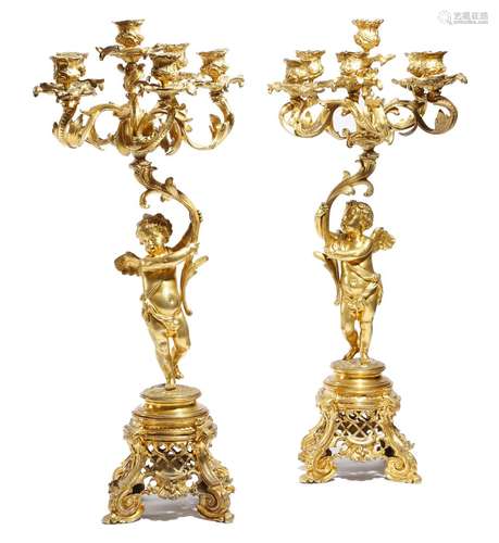 A pair of Napoleon III ormolu figural six-light candelabra in Louis XV style, each with a winged