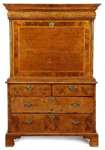 A Queen Anne walnut escritoire, the moulded cornice above a cushion drawer, the cross and feather